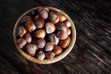 Cup with nuts Hazelnut on a wooden table
