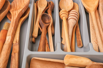 Wooden kitchen utensils in drawer, closeup