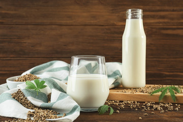 Composition with hemp milk on wooden background