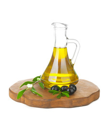 Pitcher with olive oil and wooden board on white background