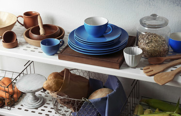 Colorful kitchenware and bread on storage stand indoors
