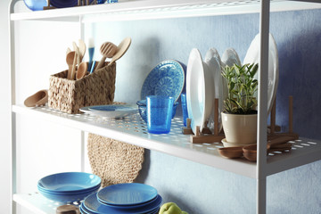 Colorful tableware on storage stand indoors