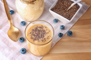 Composition with glass of delicious chia smoothie on table