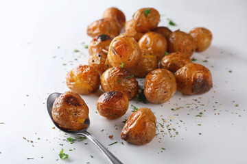 Many baked potatoes on white background