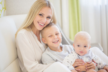 Fototapeta na wymiar Portrait of happy mother with two sons
