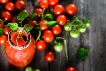 Bottle of tomato juice and fresh tomatoes, red drink, healthy antioxidant, organic food and weight loss concept