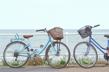 Fototapeta premium Two bicycles chained to the fence of promenade in Southwold, a popular seaside town in the UK