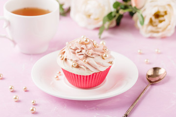 Pink cupcake decorated with pearl beads
