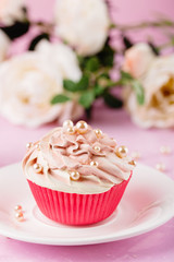 Pink cupcake decorated with pearl beads