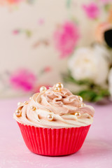 Pink cupcake decorated with pearl beads