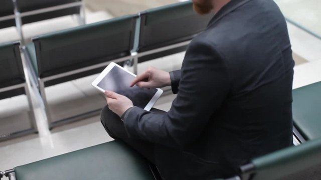 Business Man Working on a Tablet in an Empty Conference Room