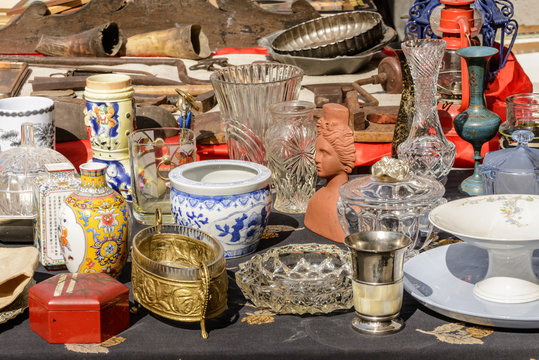jumble of knick-knack and  trinkets on sale at street market, Chiavari, Italy
