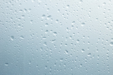 Light rain on the window glass, grainy texture on background