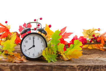 Autumn time - fall multicolored leaves with alarm clock border isolated on white background