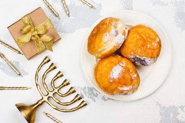 Happy Hanukkah background with menorah, burning candles and donuts. Space for text
