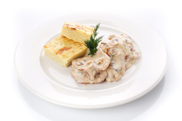 Delicious lunch. Casserole with mushroom sauce on white