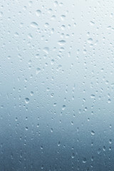 Light rain on the window glass, grainy texture on background