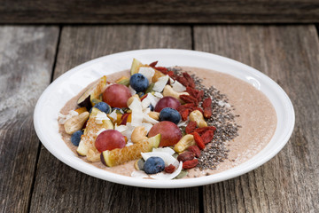 oatmeal with fruit, nuts and Chia on the wooden table