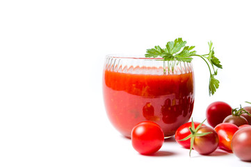 Ketchup and small cherry tomatoes on white background