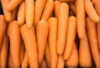 Close up a fresh carrots for background. The Carrot is root vegetable, usually orange in colour, though purple,  yellow cultivars exist.