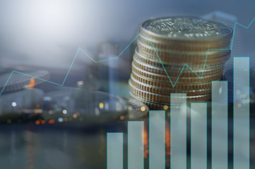 Double exposure of stacked of coins with graph and night city, concept as finance and capital banking