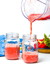 Pouring tomato juice from a blender to jar