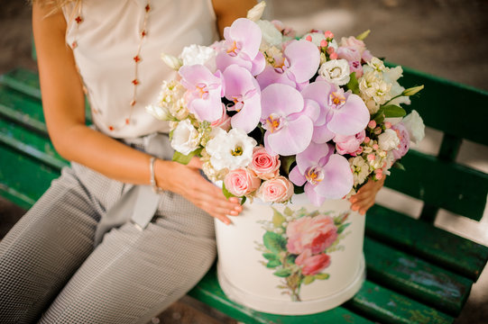 Woman with a lovely composition of beautiful flowers