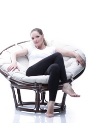 Fototapeta na wymiar young woman resting in a circular chair with rattan