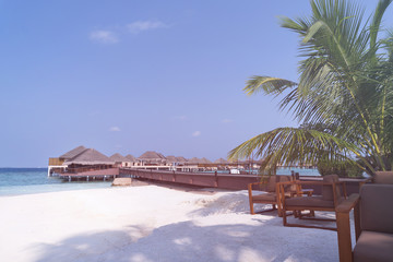Obraz na płótnie Canvas Tropical travel destination with pristine beach and water bungalows