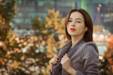 portrait of a beautiful woman in the autumn city park