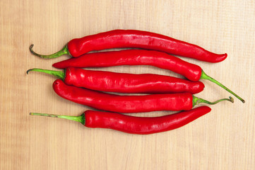 fresh red chilies on a wooden background
