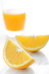 Sliced orange and glass of orange juice.
