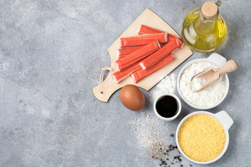Ingredients for fried crab sticks - surimi,  flour, breadcrumbs, egg, oil, soy sauce. Top view, Copy space
