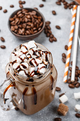 Chocolate frappe coffee with marshmallows and syrup in a Mason jar . Selective focus