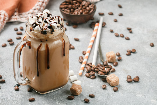 Chocolate frappe coffee with marshmallows and syrup in a Mason jar . Selective focus