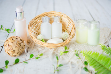 Bathroom accessories. Shower gel, body lotion, shampoo on white wooden background for the bath.