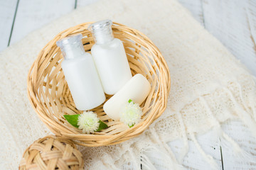 Fototapeta na wymiar Bathroom accessories. Shower gel, body lotion, shampoo on white wooden background for the bath.