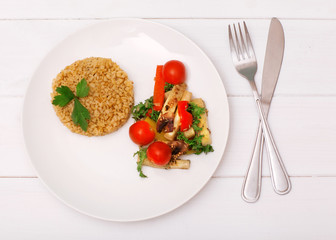 Juicy bulgur with vegetables on a white background