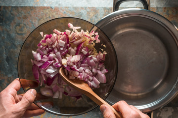 Pieces of red onions in a glass bowl and saucepan