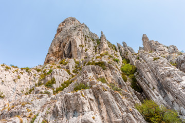 Rocks covered with grass against the sky with clouds