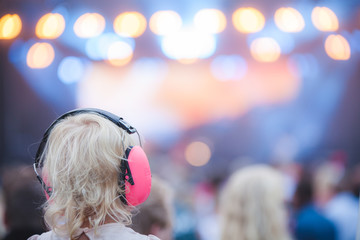 Girl with ear protectors on concert