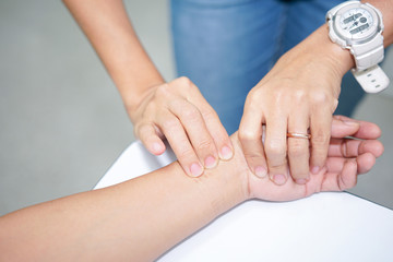 Hand feel for the pulse of the people who are unconscious. Radial Pulse Assessment.
