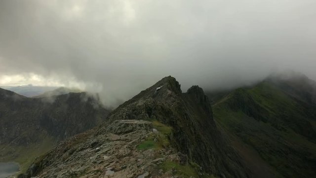 Mountain hiking on the summit of Crib Goch in Snowdonia, Wales, UK.