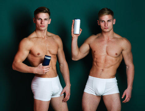 Men with naked torso on green background. Twin athletes