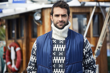 Fashionable fisherman in knitwear and body warmer, portrait