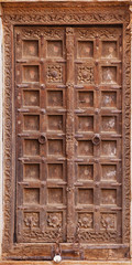 Jaisalmer, India. Old crooked wooden door. Usual entrance to the town house