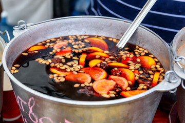A bowl and ladle of hot spicy mulled wine