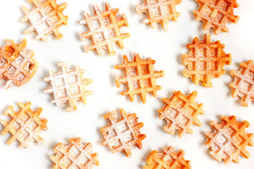 Many small waffles with poudered sugar