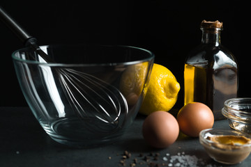 Fototapeta na wymiar Eggs, olive oil, mustard on a black background