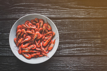 on a white plate on wooden background shrimp